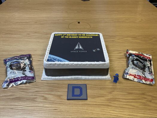 Members of the 100th Air Refueling Wing celebrated the U.S. Space Force’s second birthday with cake and astronaut ice cream sandwiches at Royal Air Force Mildenhall, England, Dec. 20, 2021. The Space Force is part of the Department of the Air Force and is the youngest branch of the U.S. military. (U.S. Air Force photo by Senior Airman Joseph Barron)