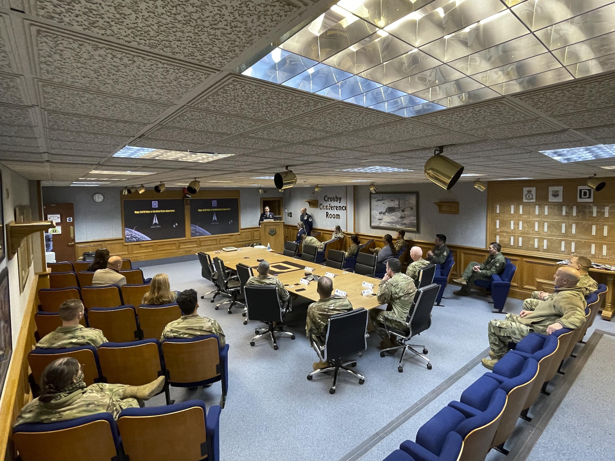 Members of the 100th Air Refueling Wing listen to a briefing about U.S. Space Force history during a celebration of the Space Force’s second birthday at Royal Air Force Mildenhall, England, Dec. 20, 2021. The Space Force is the youngest branch of the U.S. armed forces and was created Dec. 20, 2019. (U.S. Air Force photo by Senior Airman Joseph Barron)