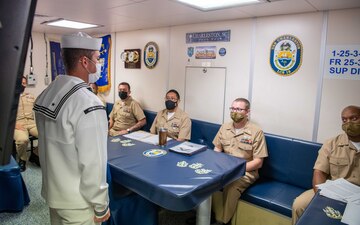 Operations Specialist 1st Class Corey Love participates in a Senior Sailor of the Quarter board aboard USS Charleston (LCS 18) at Naval Base Guam.