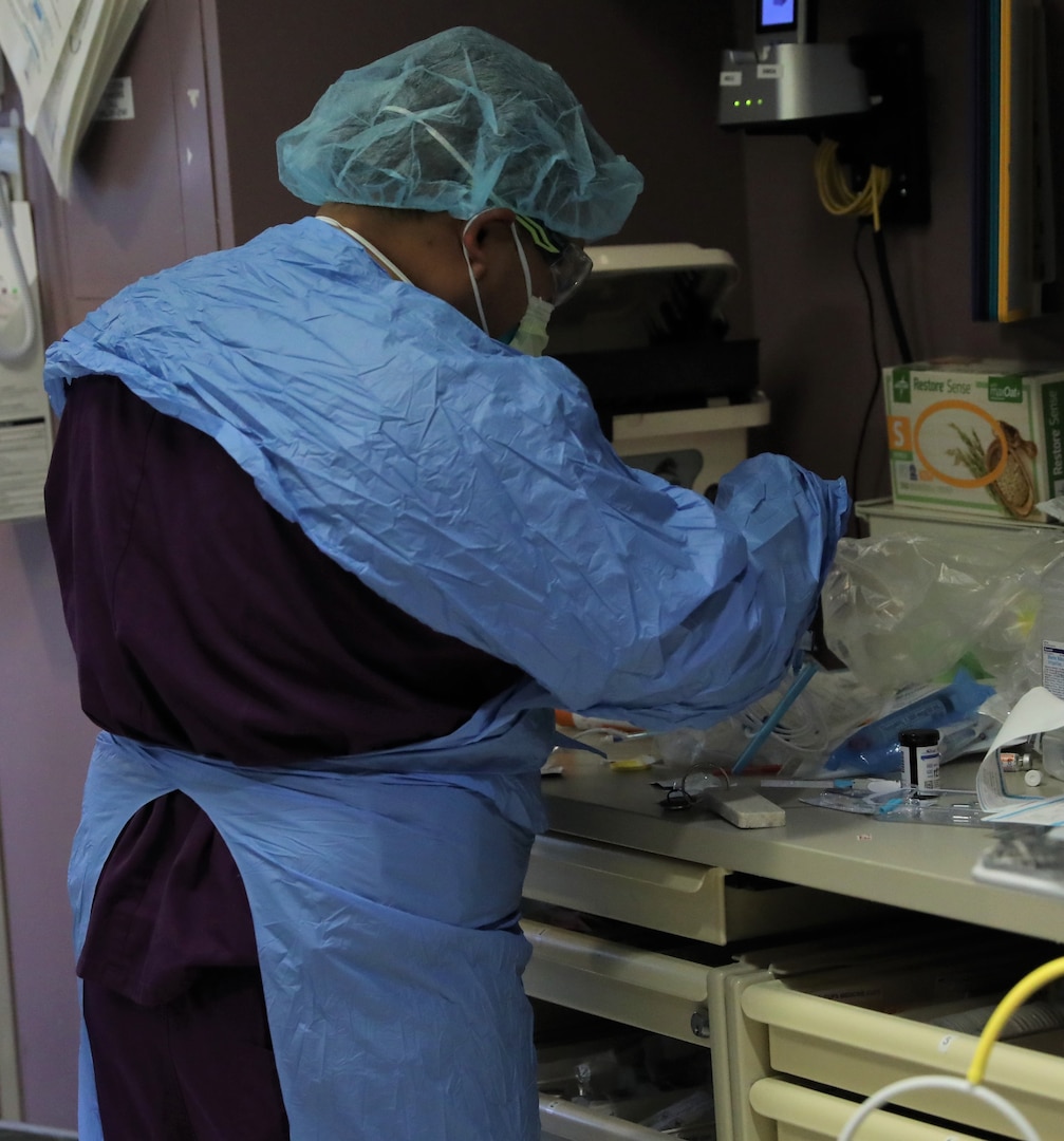 A respiratory care practitioner assigned to Joint Base San Antonio-Fort Sam Houston, Texas, prepares a sedative medication.