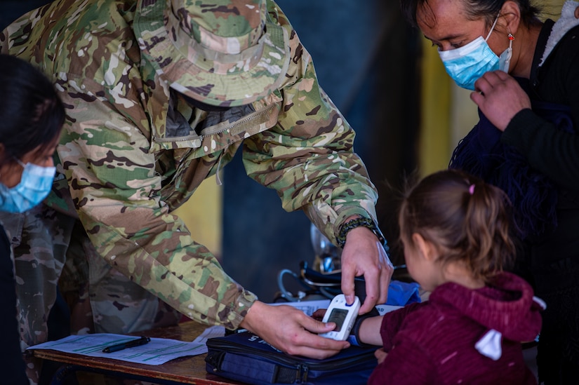 U.S. Army Spc. Alexander Beach, a medic assigned to the 256th Field Hospital, Joint Task Force Bravo, checks a young girl’s blood pressure during a global health engagement in the Chiantla region of Guatemala, Dec. 13, 2021.