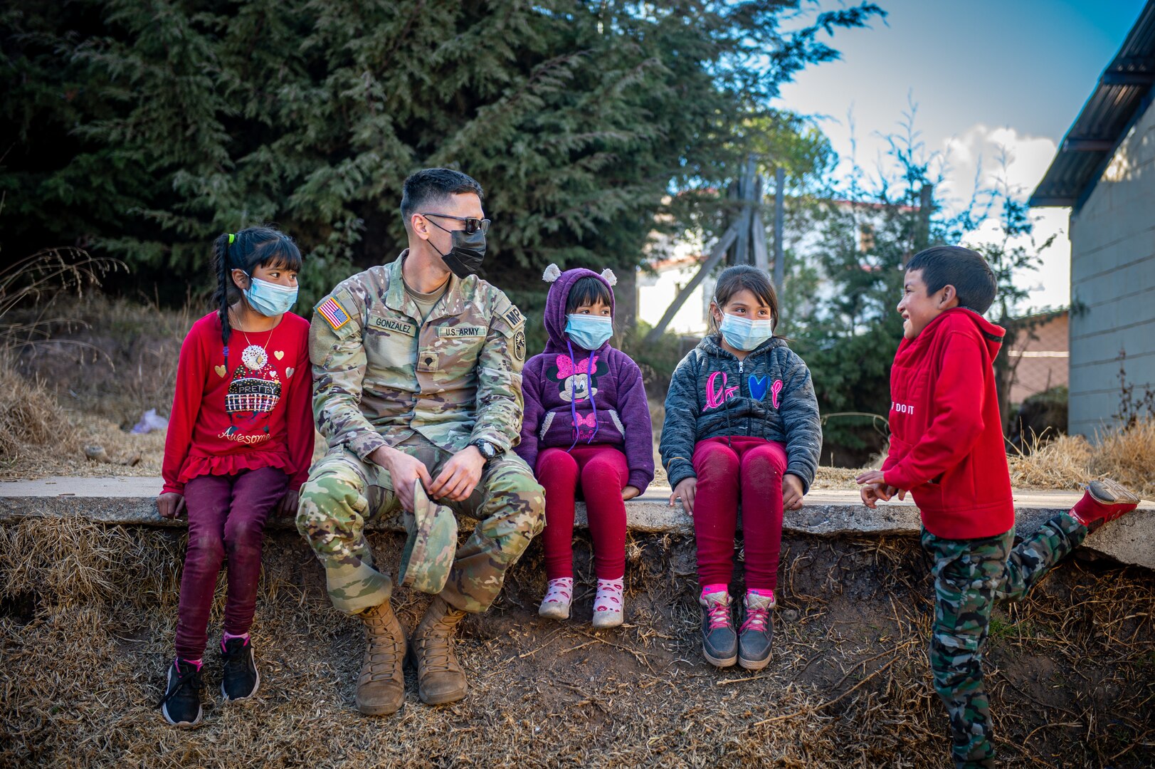 U.S. Army Spc. William Gonzalez, a military policeman with Joint Task Force Bravo, talks with local children during a global health engagement in the Chiantla region of Guatemala, Dec. 13, 2021.