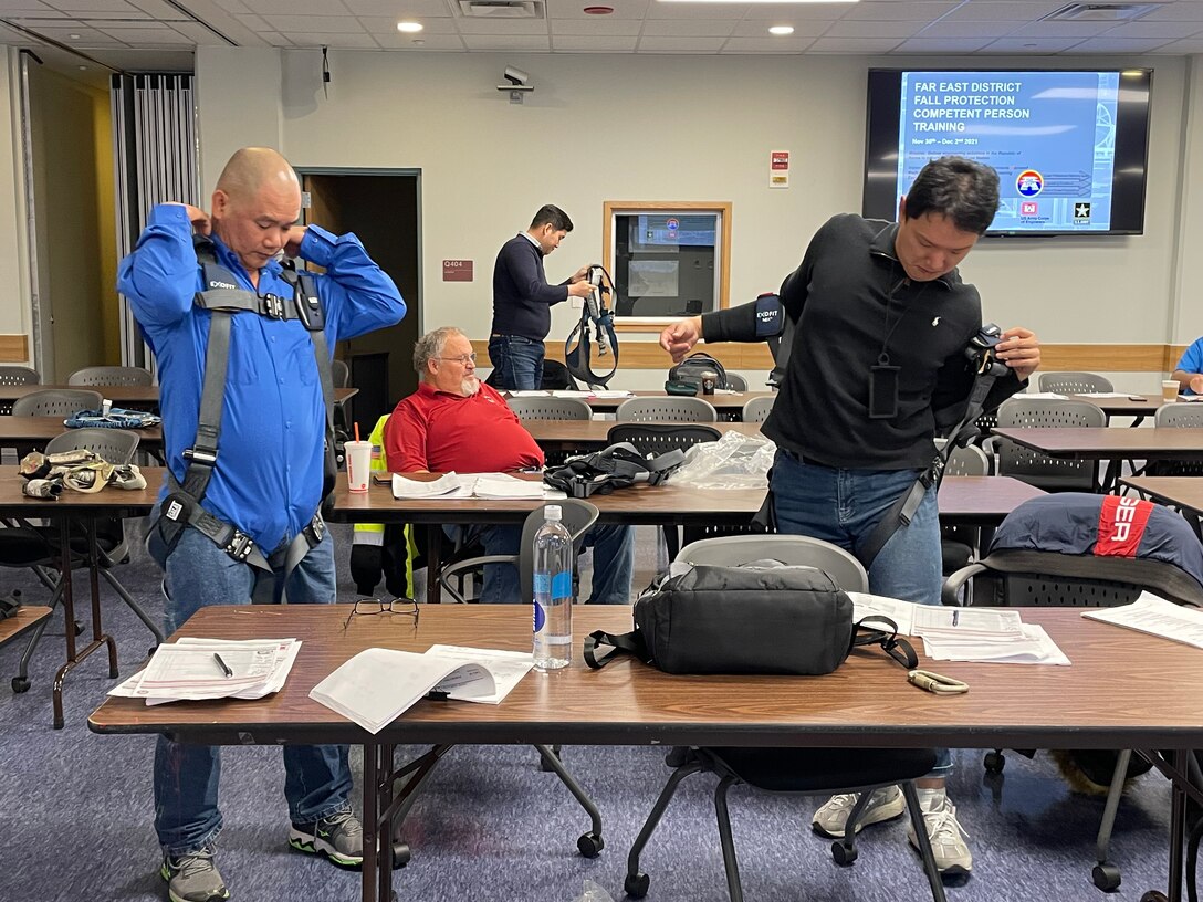 FED personnel take a hands-on approach by fitting the latest harness equipment during Fall Protection training at the Far East District Headquarters, Nov. 30.