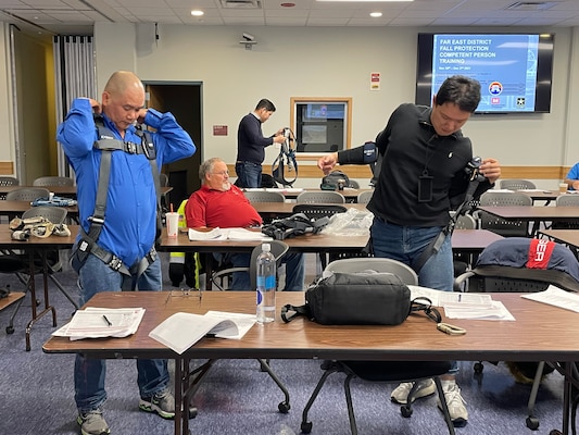 FED personnel take a hands-on approach by fitting the latest harness equipment during Fall Protection training at the Far East District Headquarters, Nov. 30.