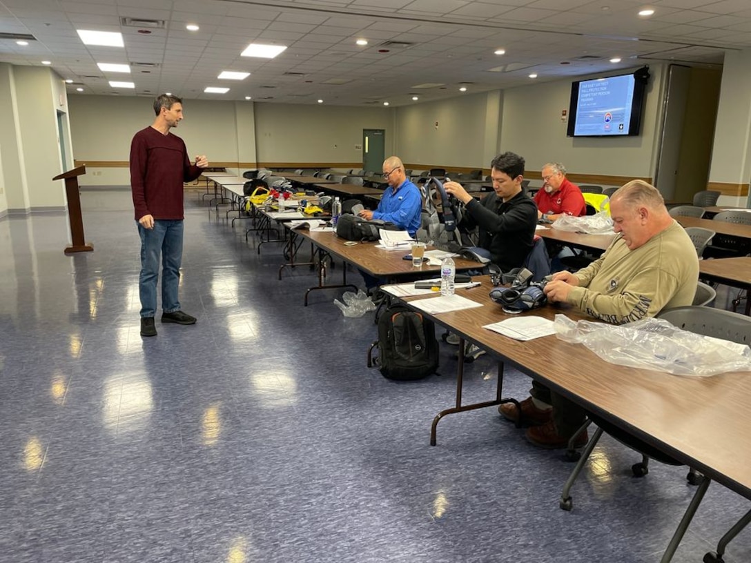 Chad Hudson, an FED Security and Operations Resident Office construction representative and fall protection program administrator, highlights the importance of anchoring a harness properly during Fall Protection training at the Far East District Headquarters, Nov. 30.