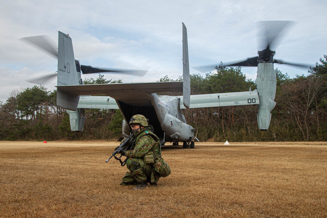 A soldier with the Japan Ground Self-defense Force provides security after being inserted into a landing zone from an MV-22 Osprey from Marine Medium Tiltrotor Squadron 262, 1st Marine Aircraft Wing during Resolute Dragon 21, on Ojojihara Proving Grounds, Dec. 9, 2021. RD21 is the largest bilateral field training exercise between the U.S. Marine Corps and JGSDF since 2013 and is the largest ever in Japan. RD21 is designed to strengthen the defensive capabilities of the U.S.-Japan Alliance by exercising integrated command and control, targeting, combined arms, and maneuver across multiple domains. 2/7 is forward deployed in the Indo-Pacific in support of 4th Marines, 3d Marine Division as part of the Unit Deployment Program. (U.S. Marine Corps photo by Lance Cpl. Diana Jimenez)