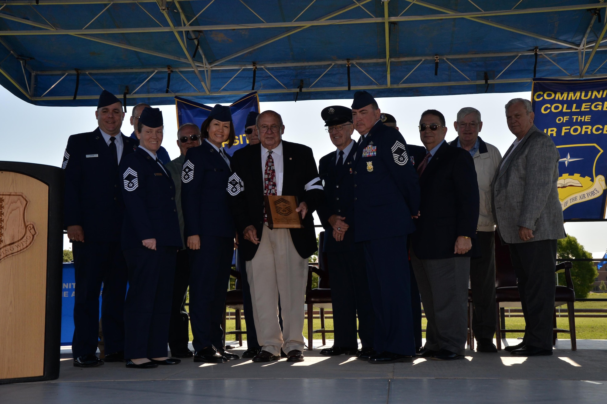 U.S. Air Force Col. Charlie E. Powell, retired, stands with Goodfellow chief master sergeants after receiving an honorary induction on Goodfellow Air Force Base, Texas, April 28, 2016.  Receiving an induction to the rank of chief master sergeant is one of the highest honors an enlisted group can bestow on a member. On his right, is 17th Training Wing command chief, Chief Master Sgt. JoAnne S. Bass, who would become the chief master sergeant of the Air Force in 2020.  (U.S. Air Force photo by Randall A. S. Moose)