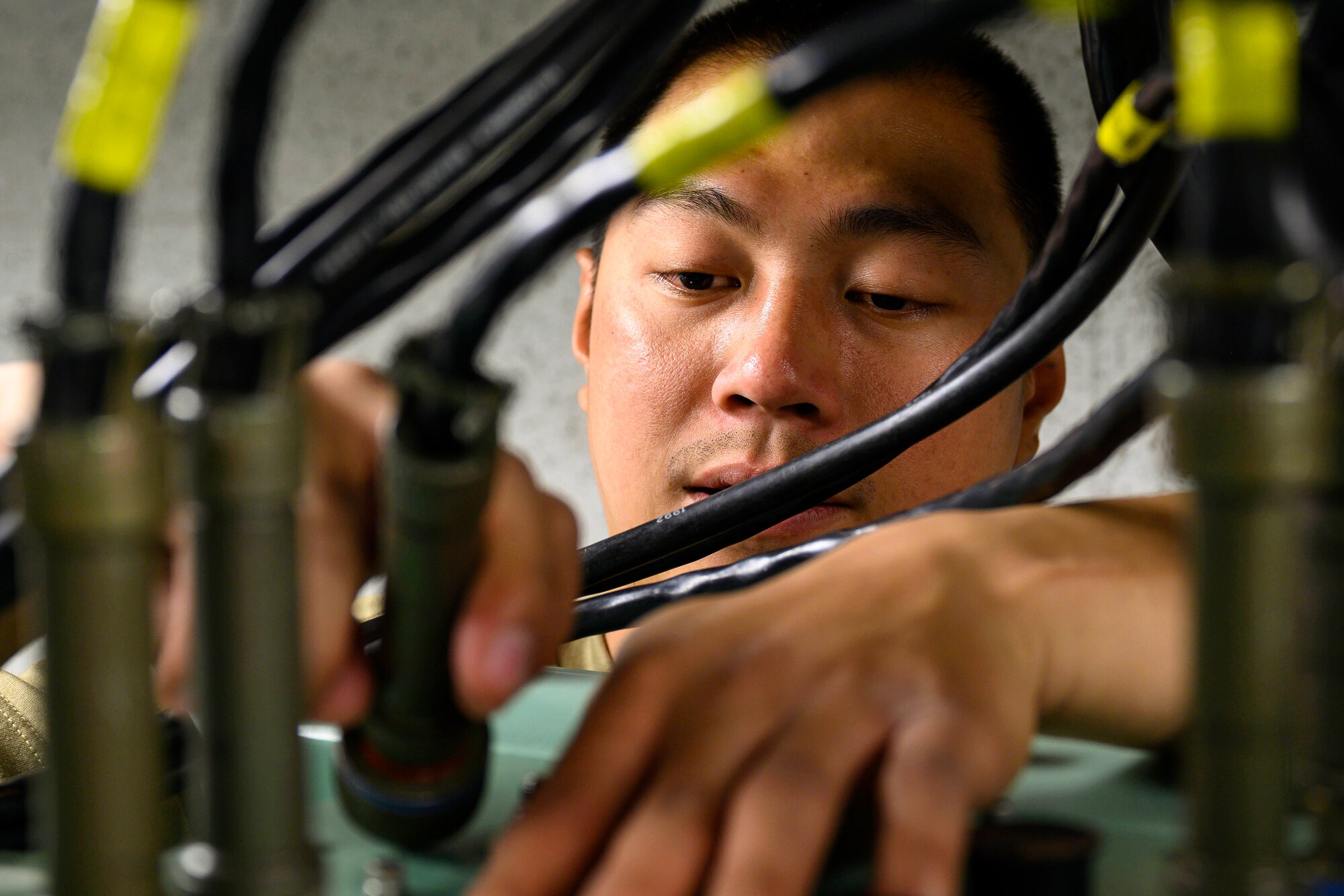 Senior Airman Jeffrey Velvis, 341st Missile Maintenance Squadron missile communications technician, conducts a cable swap