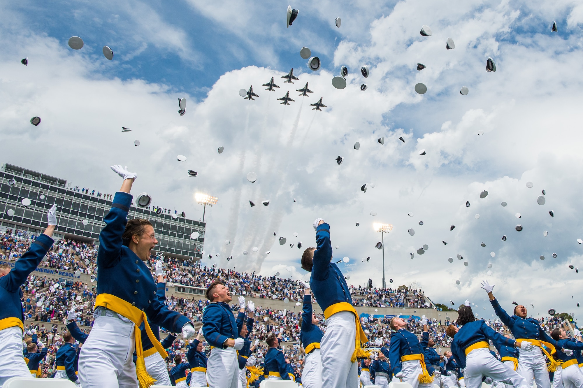 U.S. Air Force Academy Class of 2021 graduates toss their service caps as the U.S. Air Force Thunderbirds fly overhead