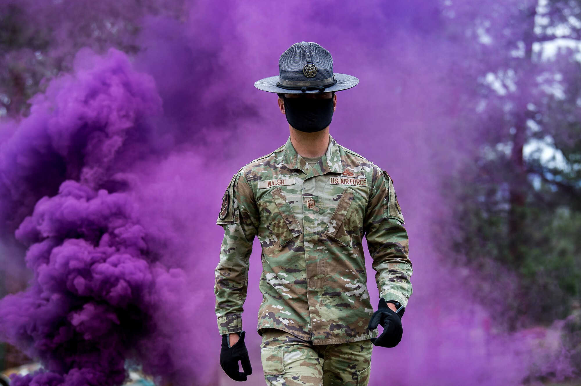 Master Sgt. Michael Walsh, military training instructor, walks through purple smoke
