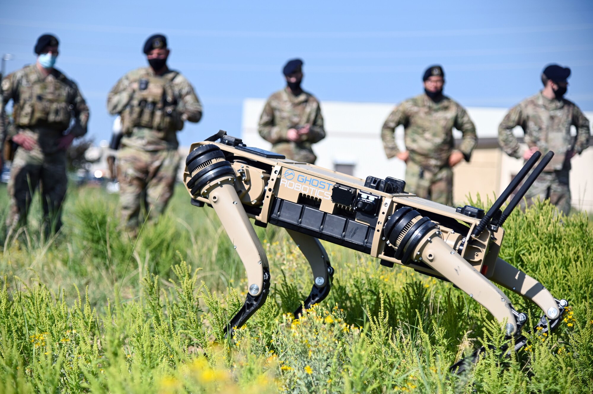 Airmen from the 75th Security Forces Squadron observe a demonstration of a Quad-legged Unmanned Ground Vehicle