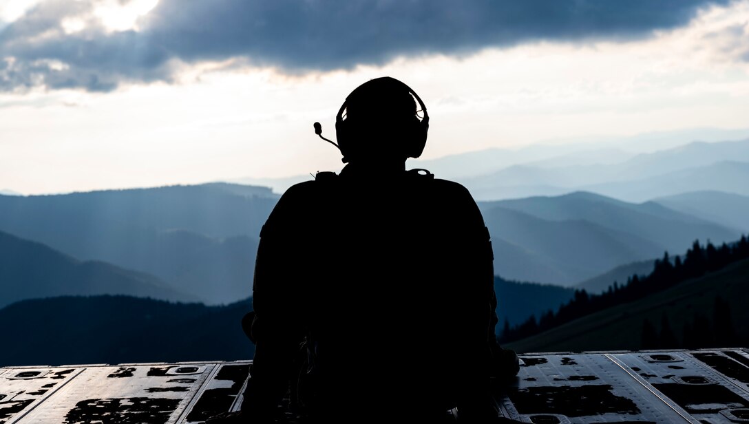A 352nd Special Operations Wing flight doctor looks out of the rear of an MC-130J Commando II