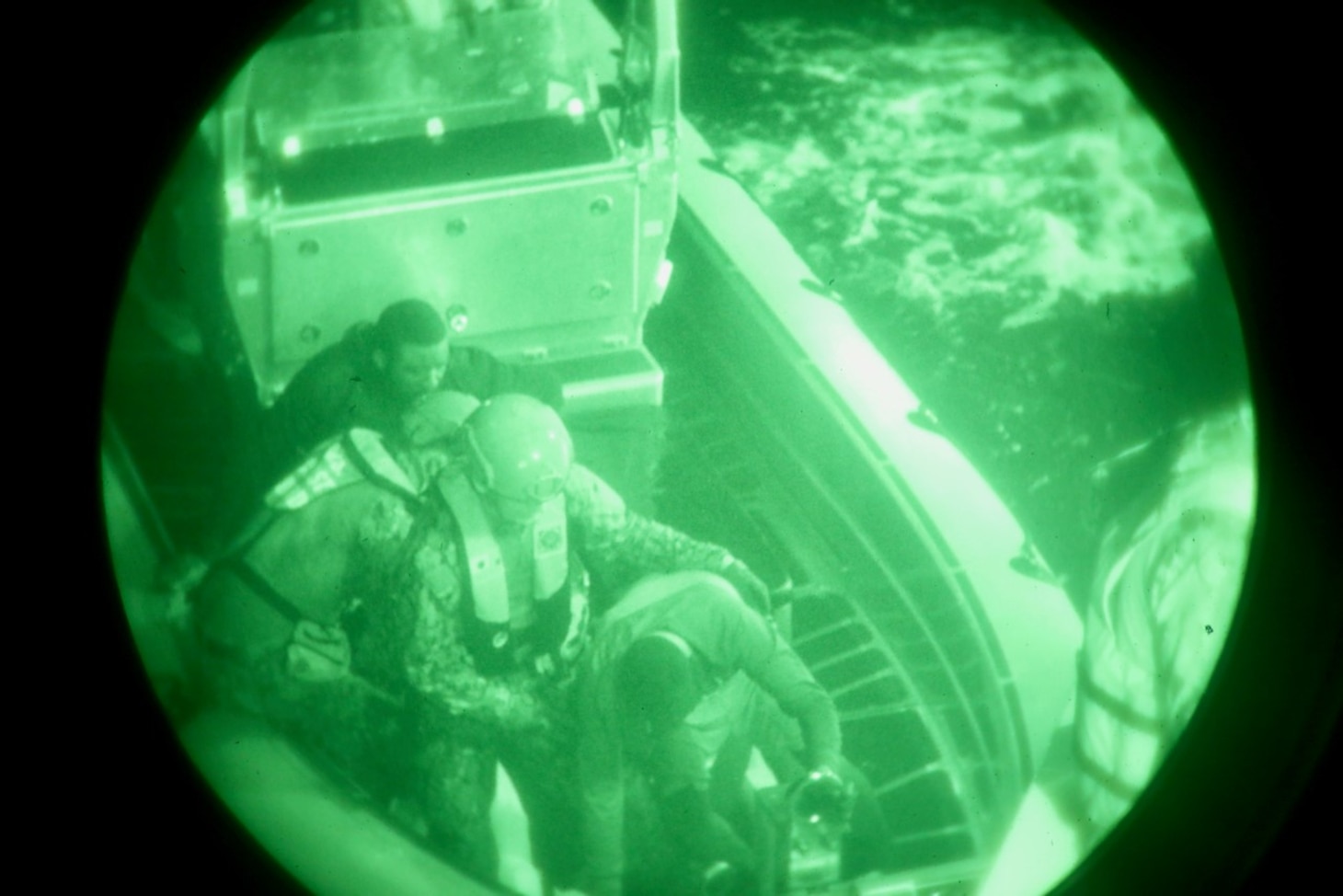 The crew of the Sentinel-class USCGC Glen Harris (WPC 1145) help rescued migrants transfer from their small boat to the cutter in the Atlantic Ocean Jan. 5, 2021.