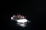 The crew of the Sentinel-class USCGC Glen Harris (WPC 1145) aboard a small boat assess an overloaded raft taking on water carrying migrants in the Atlantic Ocean prior to their subsequent rescue Jan. 5, 2021.