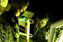 The crew of the Sentinel-class USCGC Glen Harris (WPC 1145) assists migrants rescued from the water aboard the cutter in the Atlantic Ocean Jan. 5, 2021.