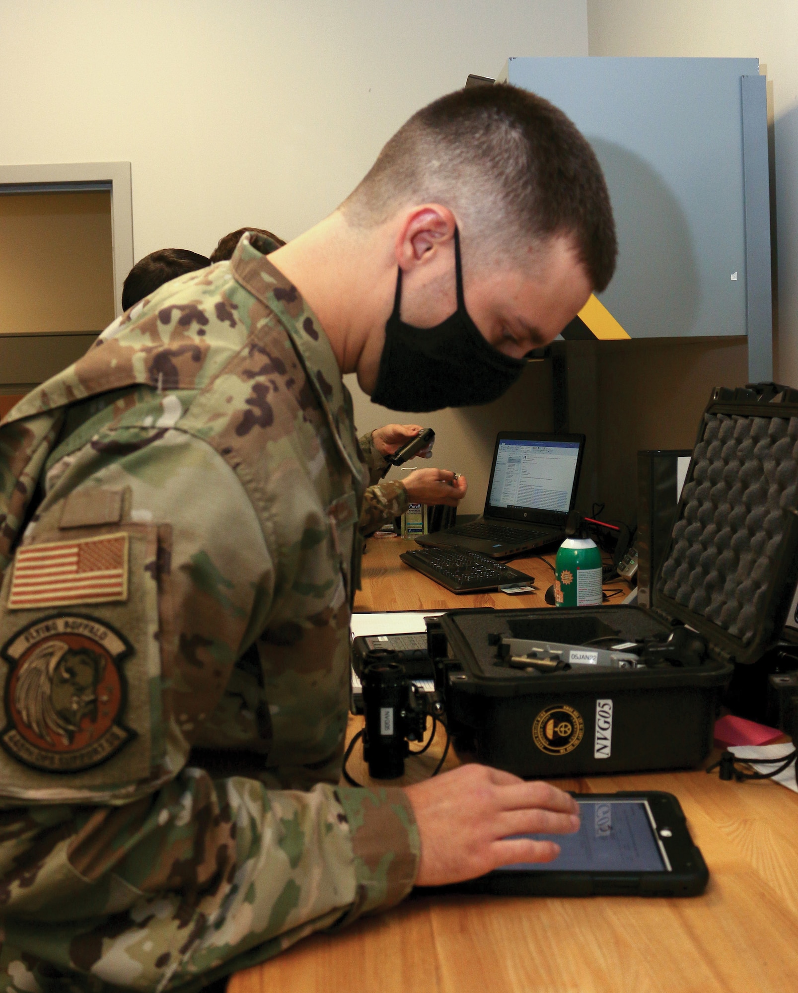 Staff Sgt. David Smith, 445th Operations Support Squadron aircrew flight equipment craftsman, checks electronic training manuals while performing operational checks on night vision goggles, Dec. 5, 2021.