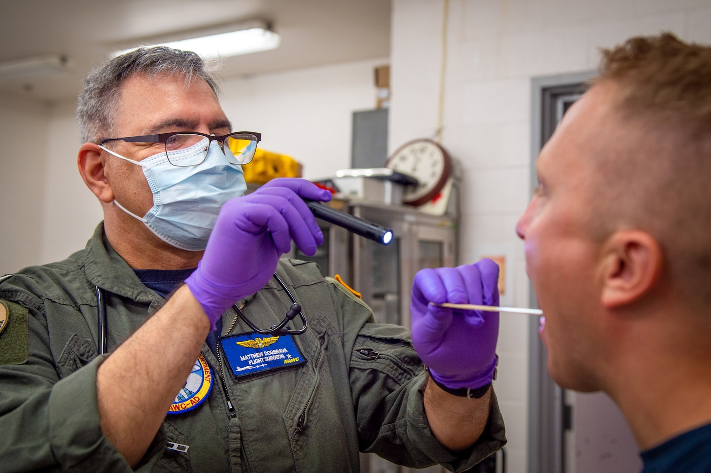 NAVAL AIR STATION PATUXENT RIVER, Md. (July 26, 2021) Cmdr. Matthew Doubrava, flight surgeon and Aeromedical Monitoring and Analysis branch head for Naval Air Warfare Center Aircraft Division (NAWCAD), conducts a medical screening on a Sailor for testing in the Environmental Physiology and Human Performance lab. (U.S. Navy photo by Mass Communication Specialist 3rd Class  Chanel L. Turner)