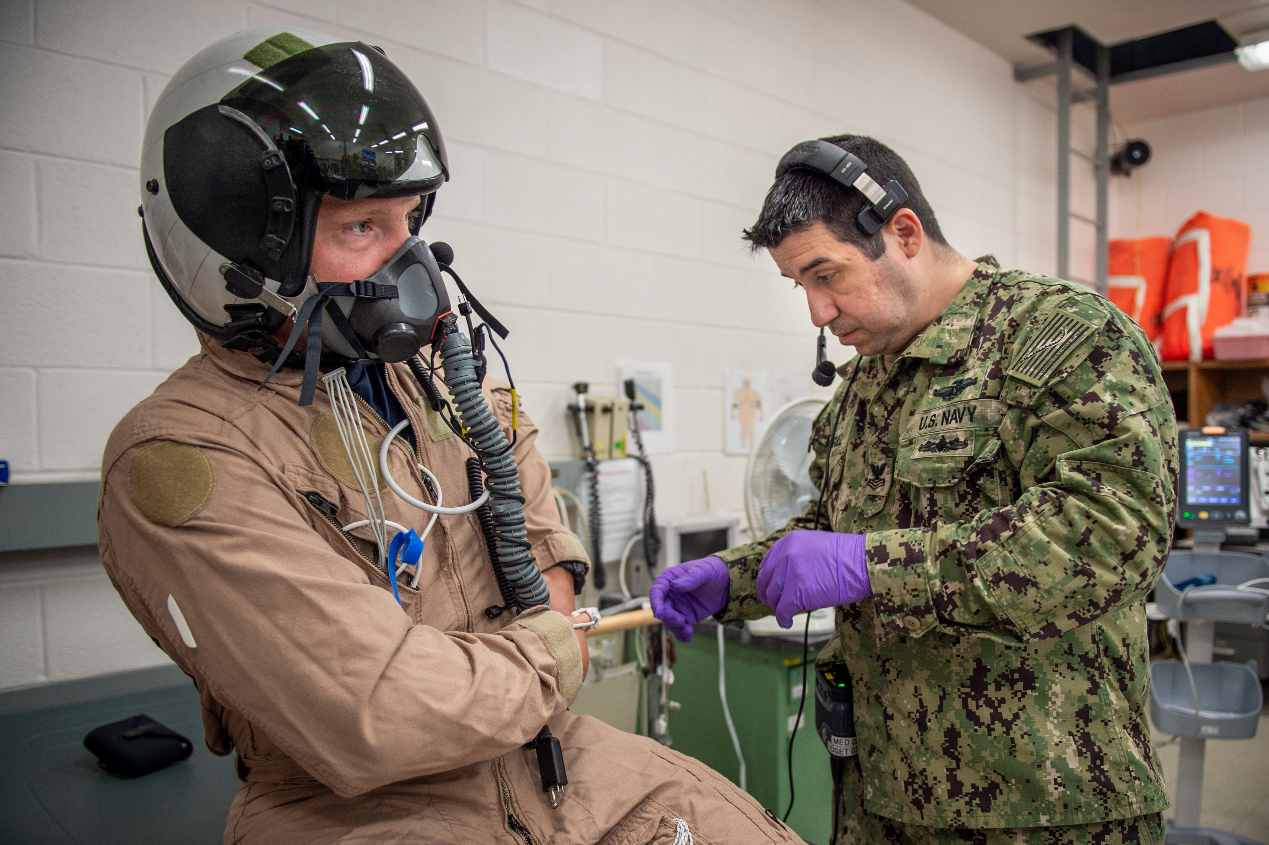 NAVAL AIR STATION PATUXENT RIVER, Md. (July 26, 2021) Lt. Cmdr. Micah Kinney, left, prepares for testing under the medical supervision of Hospital Corpsman 1st Class Sergio Rodriguez in the Environmental Physiology and Human Performance lab at Naval Air Warfare Center Aircraft Division (NAWCAD). (U.S. Navy photo by Mass Communication Specialist 3rd Class  Chanel L. Turner)