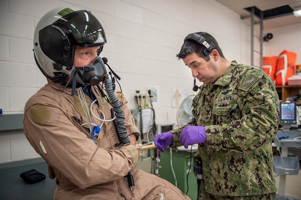 NAVAL AIR STATION PATUXENT RIVER, Md. (July 26, 2021) Lt. Cmdr. Micah Kinney, left, prepares for testing under the medical supervision of Hospital Corpsman 1st Class Sergio Rodriguez in the Environmental Physiology and Human Performance lab at Naval Air Warfare Center Aircraft Division (NAWCAD). (U.S. Navy photo by Mass Communication Specialist 3rd Class  Chanel L. Turner)