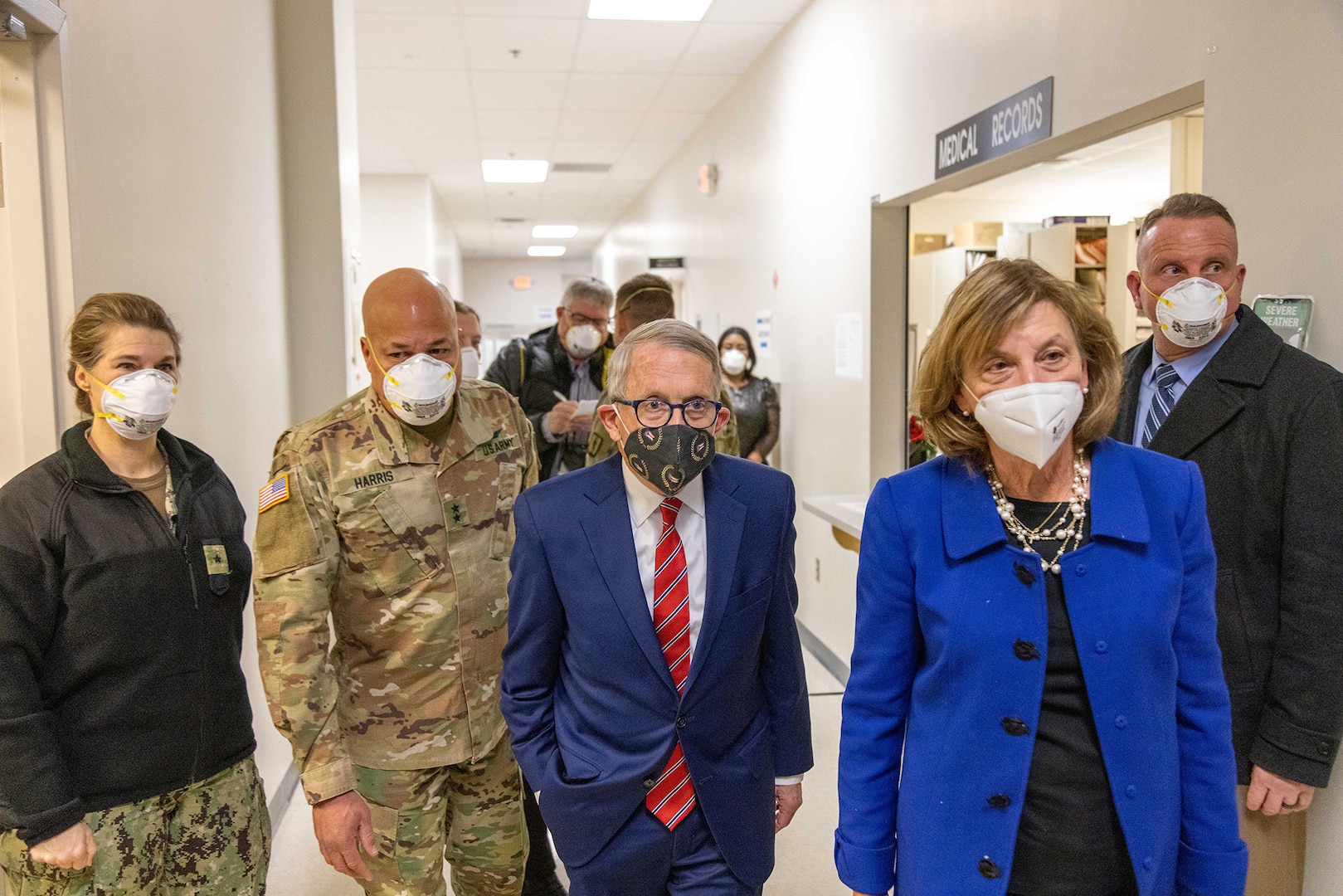 Commander Fabry in a Navy utility uniform, Gen. Harris in a OCP uniform, Gov. DeWine in a dark blue suit and his wife, Fran in a lighter blue suit.