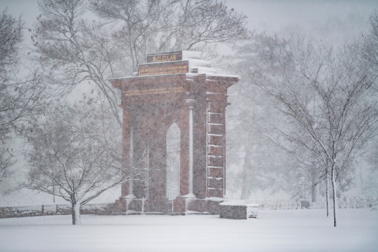 Snow falls over a building.