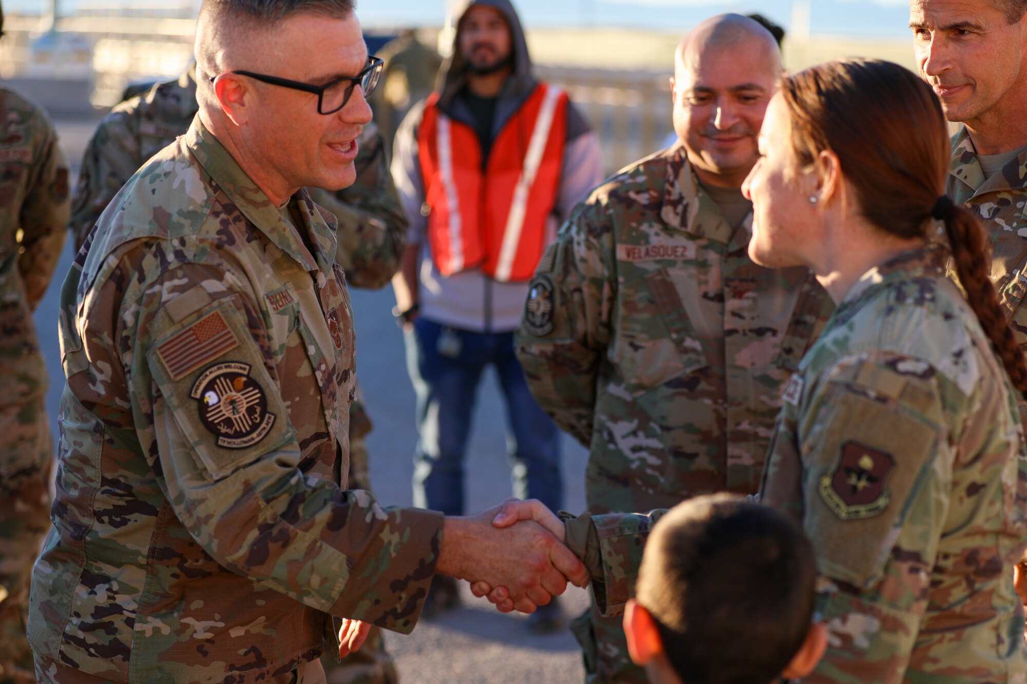 U.S. Air Force Chief Master Sgt. Mikael Sundin, Continental U.S. North American Aerospace Defense Command Region and 1st Air Force (Air Forces Northern) command chief, shakes hands with an Airman assigned to Task Force Hollman during his visit to Holloman Air Force Base, New Mexico, Jan. 4, 2022. The Department of Defense, through the U.S. Northern Command, and in support of the Department of State and Department of Homeland Security, is providing transportation, temporary housing, medical screening, and general support for at least 50,000 Afghan evacuees at suitable facilities, in permanent or temporary structures, as quickly as possible. This initiative provides Afghan evacuees essential support at secure locations outside Afghanistan. (U.S. Army photo by Sgt. Jose Escamilla)