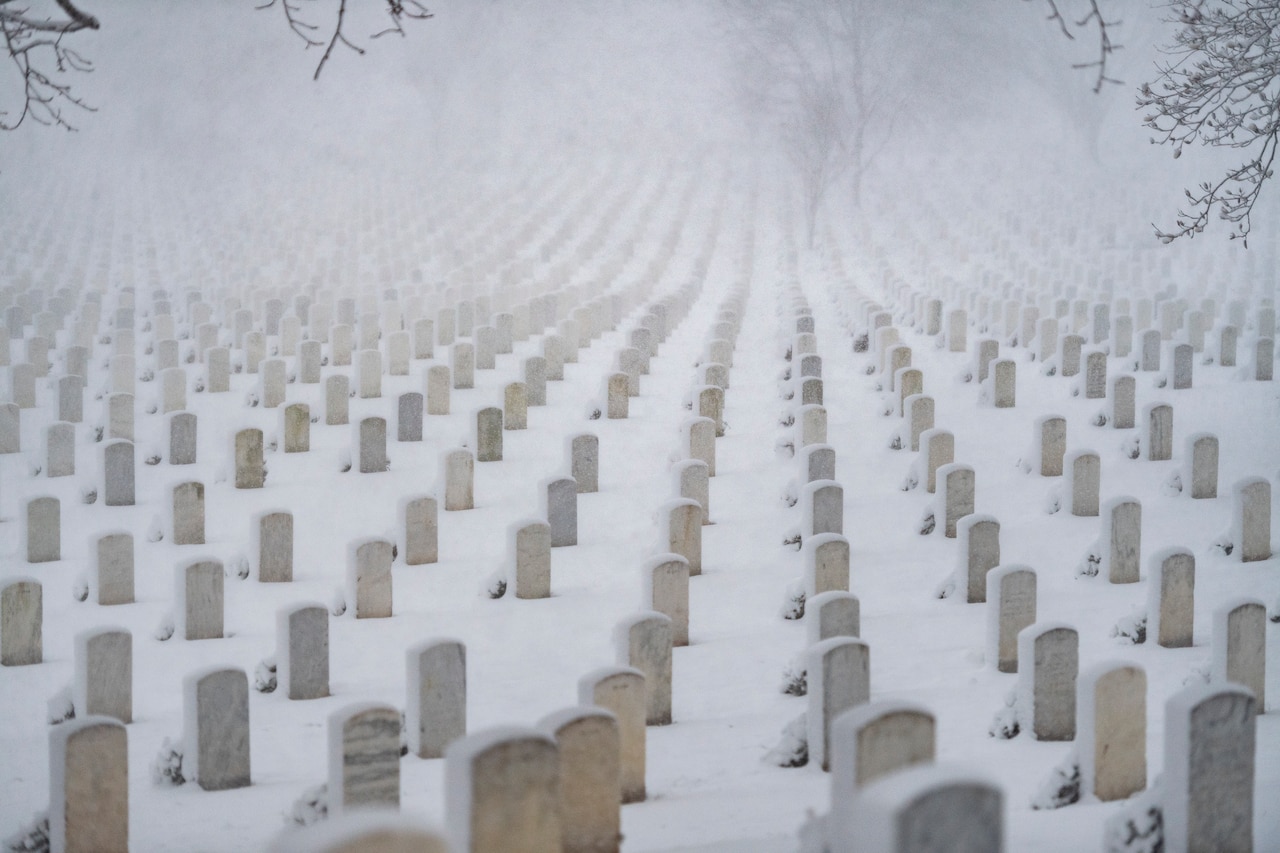 Snow covers a large area of headstones in Arlington National Cemetery.
