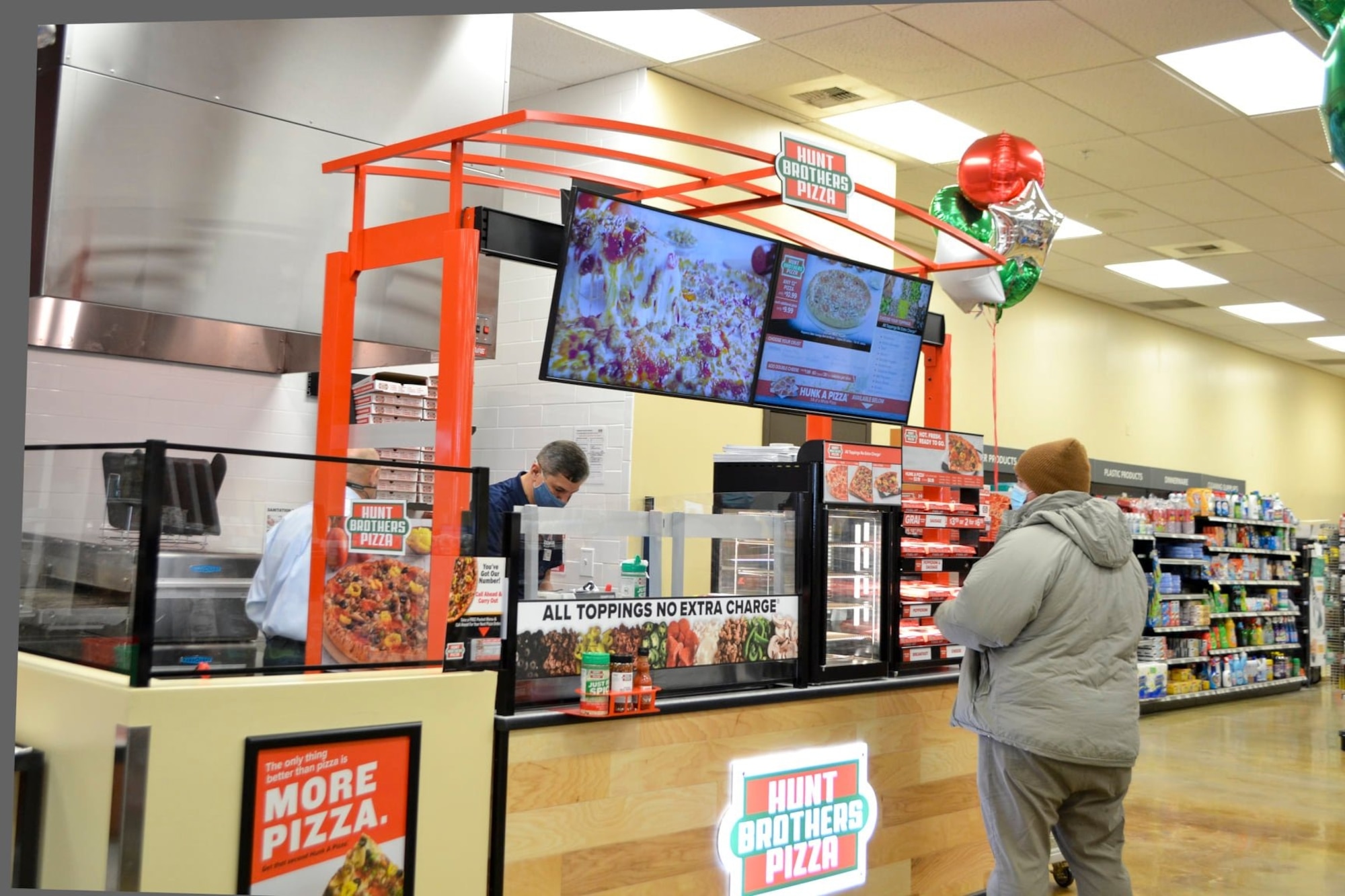 Man looking at pizza menu board