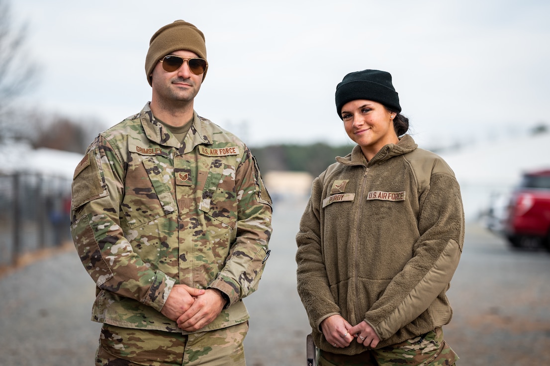 U.S. Air Force Tech. Sgt. Karl Grimsley, with the Tennessee Air National Guard, left, and Airman 1st Class Elizabeth Purdy, with the New Jersey Air National Guard's 108th Wing stand for a portrait in Liberty Village on Joint Base McGuire-Dix-Lakehurst, N.J., Dec. 9, 2021