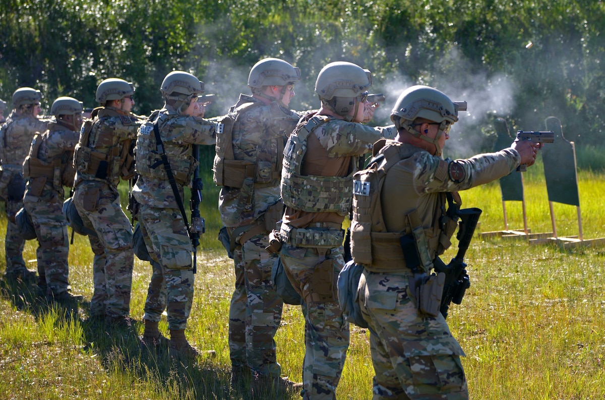Airmen from the 354th Security Forces Squadron fire handguns during a Special Response Team tryout June 23, 2021, on Eielson Air Force Base Alaska. With the addition of these security forces assets, Eielson’s lethality and readiness increases tremendously. (U.S. Air Force photo by Staff Sgt. Beaux Hebert)