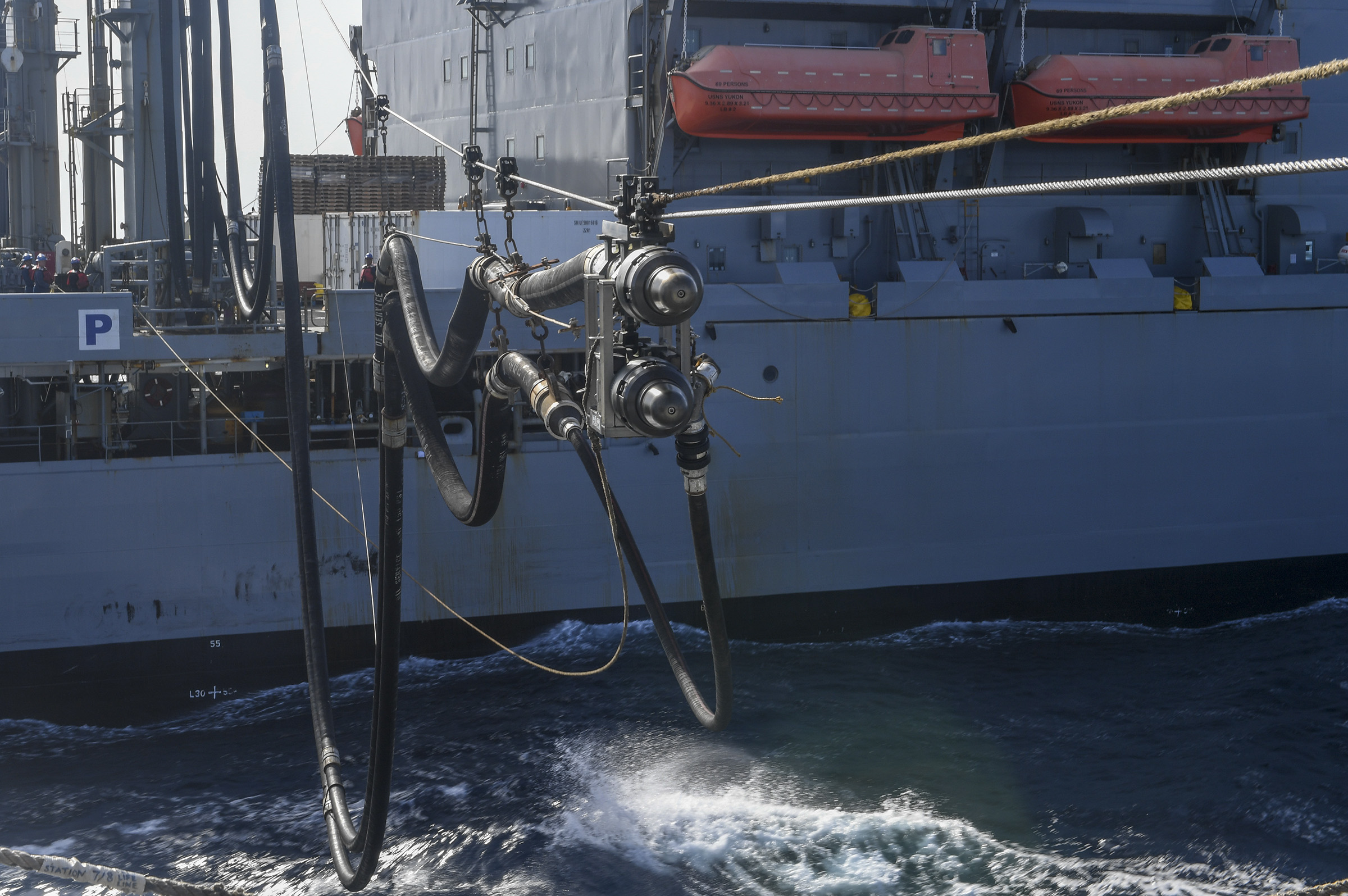 The Henry J. Kaiser-class fleet replenishment oiler USNS Yukon (T-AO 202) sends over a fuel probe line to the Arleigh Burke-class guided-missile destroyer USS Chafee (DDG 90) during a replenishment at sea.