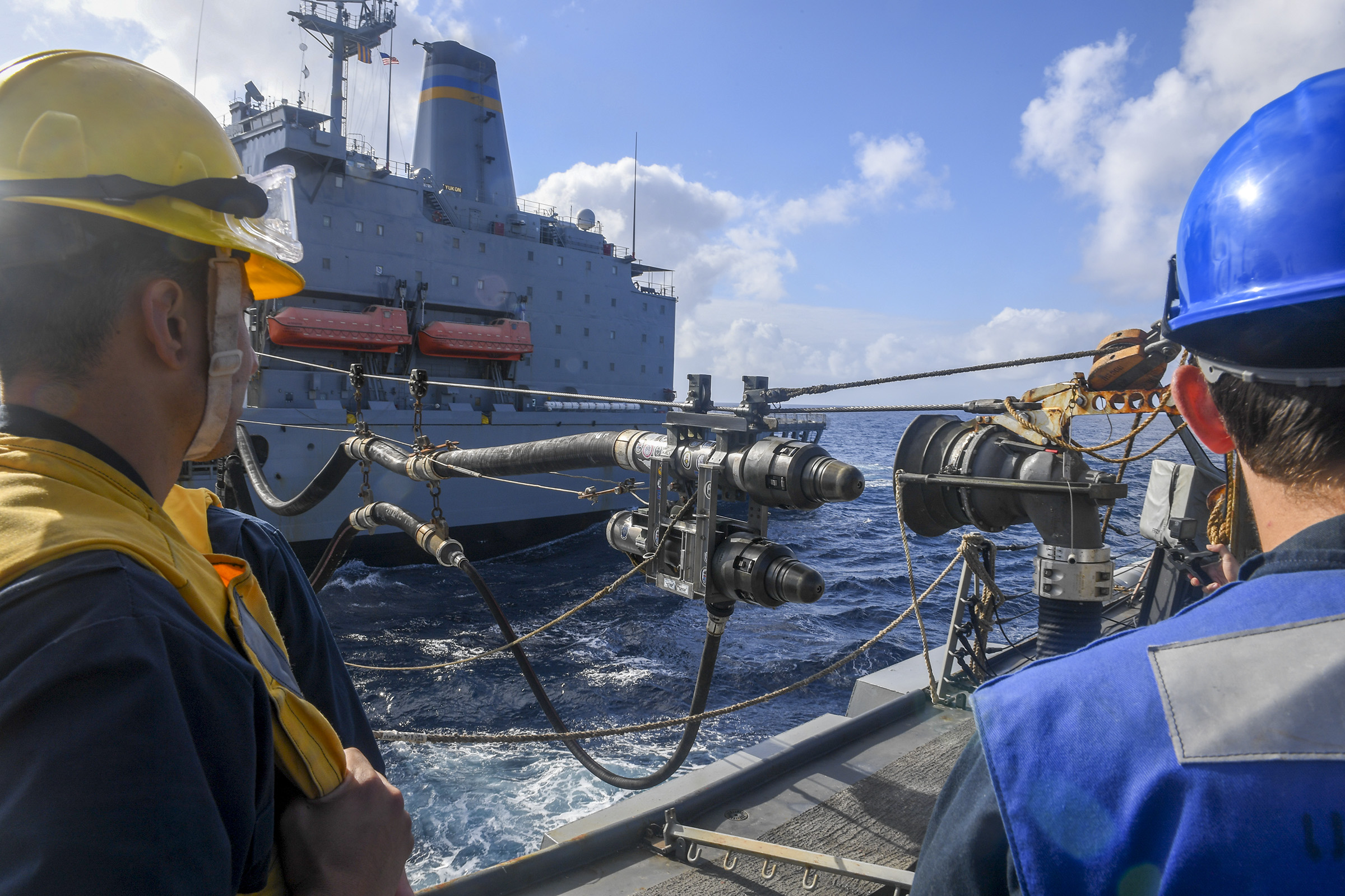 Sailors aboard the Arleigh Burke-class guided-missile destroyer USS Chafee (DDG 90) recieve a fuel probe from the Henry J. Kaiser-class fleet replenishment oiler USNS Yukon (T-AO 202) during a replenishment at sea.