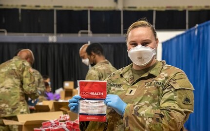 U.S. Army 1st Lt. Taylor Stalnaker, District of Columbia Army National Guard, holds up an assembled COVID self-testing kit at the D.C. Armory, Jan. 6th, 2022. The kit is one of hundreds of thousands that nearly 100 D.C. National Guard members are assembling in support of D.C. Health as it confronts a surge in need for tests. (U.S. Air National Guard photo by Tech. Sgt. Andrew Enriquez)
