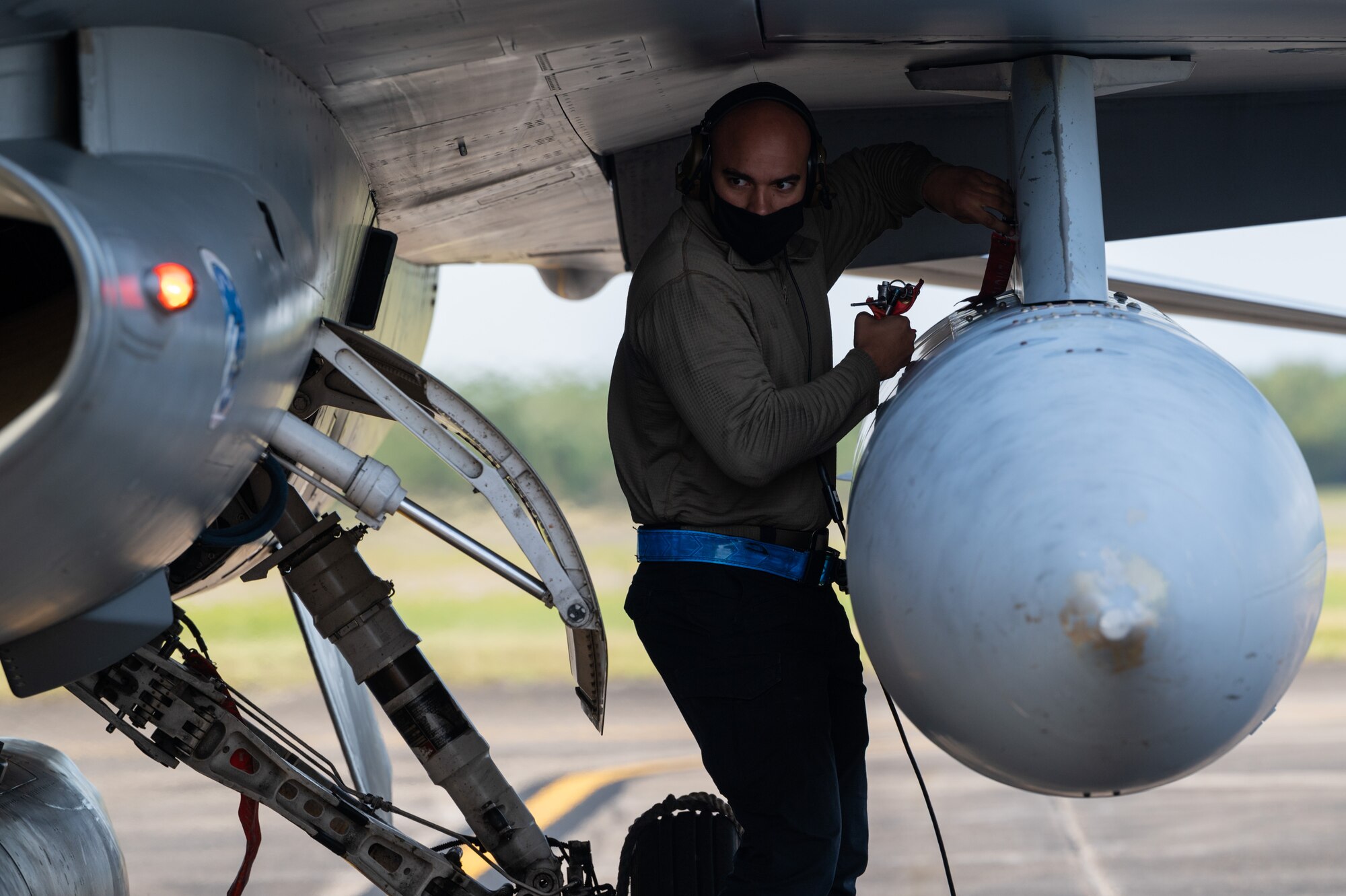 Staff Sgt. Austin Wall of the 162nd Wing, Arizona Air National Guard, completes preflight checks of an F-16 fighter aircraft while communicating with the pilot at Naval Air Station Joint Reserve Base New Orleans, November 4. The mission is part of Operation Southern Lightning Strike, an Air National Guard led exercise where units deploy from their home bases to forward operating bases with minimum personnel and equipment to accomplish the mission in austere conditions. (U.S. Air National Guard Photo by Technical Sgt. H. Edward Stramler)