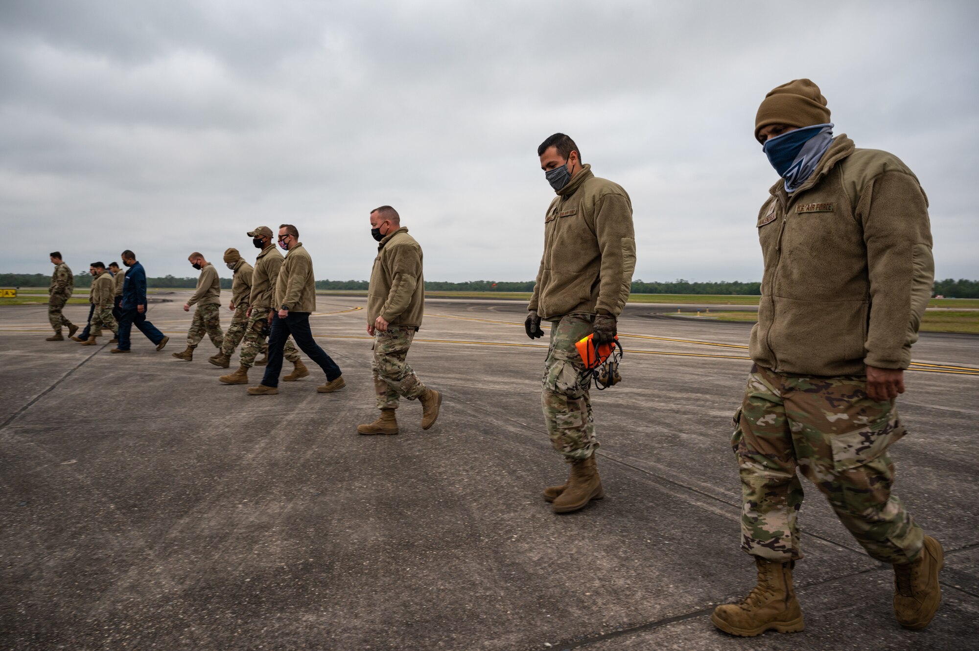 Airmen from the 162nd Wing, Arizona Air National Guard, conduct their daily F.O.D. (foreign object damage) walk during Operation Southern Lightning Strike 2021 at Naval Air Station Joint Reserve Base New Orleans, November 5. Personnel look for and collect any loose items on the flight line that could damage the engines of the F-16 fighter aircraft that they maintain. (U.S. Air National Guard Photo by Tech. Sgt. H. Edward Stramler)