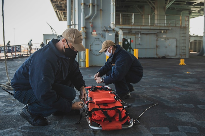 220105-M-AU949-0172 MANAMA, Bahrain (Jan. 5, 2022) – Chief Boatswain’s Mate Erick Chavez, left, and Seaman Michael Burkus, right, inspect a medical litter aboard the Expeditionary Sea Base USS Lewis B. Puller (ESB 3) Jan. 5. The Puller deployed to the U.S. 5th Fleet area of operations in support of naval operations to ensure maritime stability and security in the Central Region, connecting the Mediterranean and Pacific through the Western Indian Ocean and three strategic choke points. (U.S. Marine Corps photo by Staff Sgt. Victor A. Mancilla)