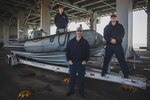 220105-M-AU949-0166 ARABIAN GULF (Jan. 5, 2022) – Boatswain’s Mate 2nd Class Adam McGreevy, left, Chief Boatswain’s Mate Erick Chavez, center, and Seaman Michael Burkus, right, pose for a photo on a rigid-hull inflatable boat aboard the Expeditionary Sea Base USS Lewis B. Puller (ESB 3) Jan. 5. The Puller deployed to the U.S. 5th Fleet area of operations in support of naval operations to ensure maritime stability and security in the Central Region, connecting the Mediterranean and Pacific through the Western Indian Ocean and three strategic choke points. (U.S. Marine Corps photo by Staff Sgt. Victor A. Mancilla)