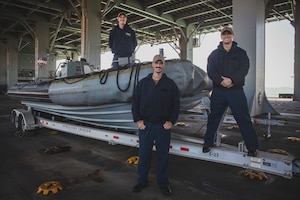 220105-M-AU949-0166 ARABIAN GULF (Jan. 5, 2022) – Boatswain’s Mate 2nd Class Adam McGreevy, left, Chief Boatswain’s Mate Erick Chavez, center, and Seaman Michael Burkus, right, pose for a photo on a rigid-hull inflatable boat aboard the Expeditionary Sea Base USS Lewis B. Puller (ESB 3) Jan. 5. The Puller deployed to the U.S. 5th Fleet area of operations in support of naval operations to ensure maritime stability and security in the Central Region, connecting the Mediterranean and Pacific through the Western Indian Ocean and three strategic choke points. (U.S. Marine Corps photo by Staff Sgt. Victor A. Mancilla)