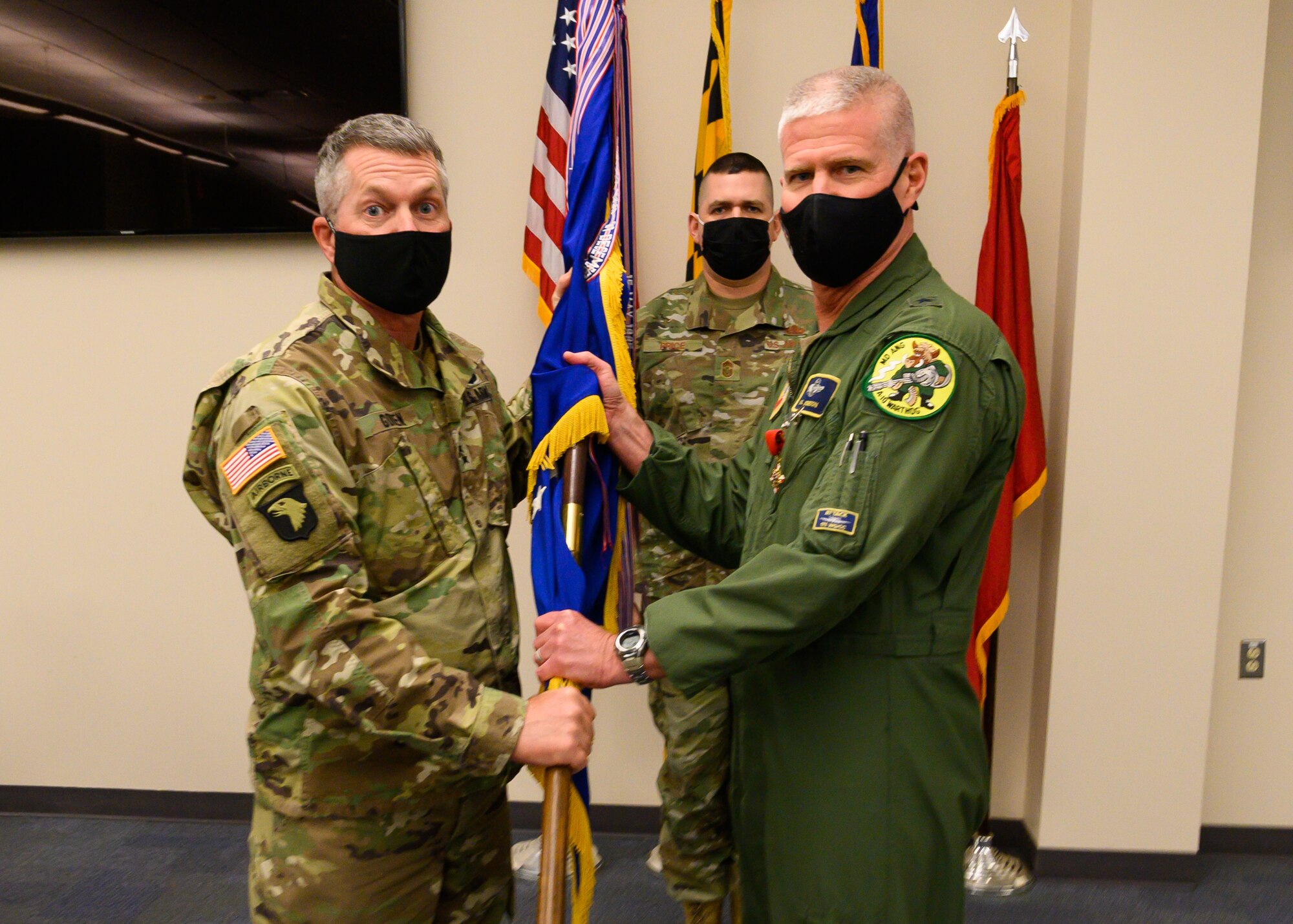 U.S. Army Maj. Gen. Timothy E. Gowen, the adjutant general for Maryland, receives the 175th Wing guidon from U.S. Air Force Brig. Gen. Paul D. Johnson, the outgoing commander of the 175th Wing, during a change of command ceremony on Jan. 7, 2022, at Warfield Air National Guard Base at Martin State Airport, Middle River, Maryland. Members of the Maryland National Guard gathered for the socially distanced ceremony to bid farewell to Johnson, the outgoing commander and welcomed U.S. Air Force Brig. Gen. Jori A. Robinson, the incoming commander.