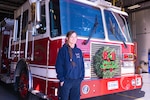Firefighter Kimberly Rauch, with the 139th Fire Department, Missouri Air National Guard, in front of a fire truck at Rosecrans Air National Guard Base, in St. Joseph, Missouri, Dec. 13, 2021. While off-duty, Rauch helped save a man trapped in a burning house.