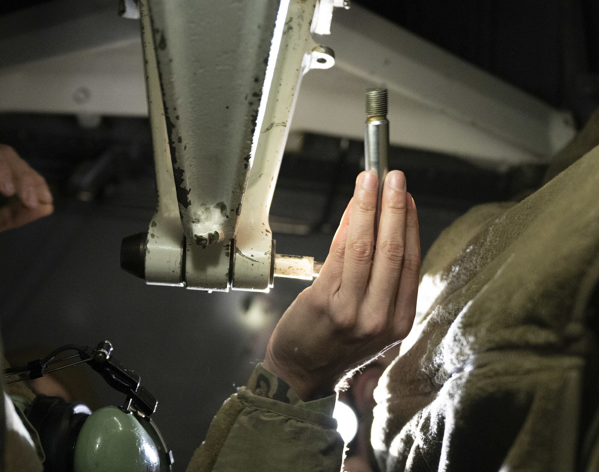 Airman holds wrench.