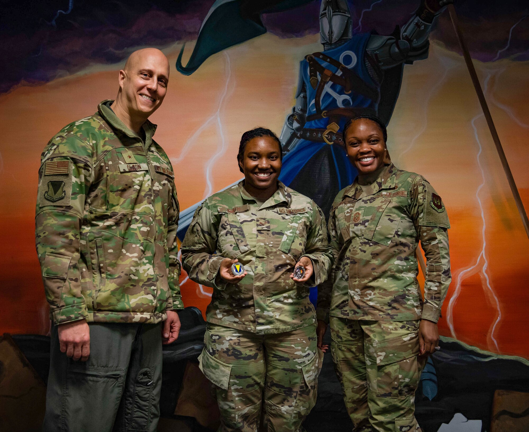 Airman poses with base leadership after receiving award.