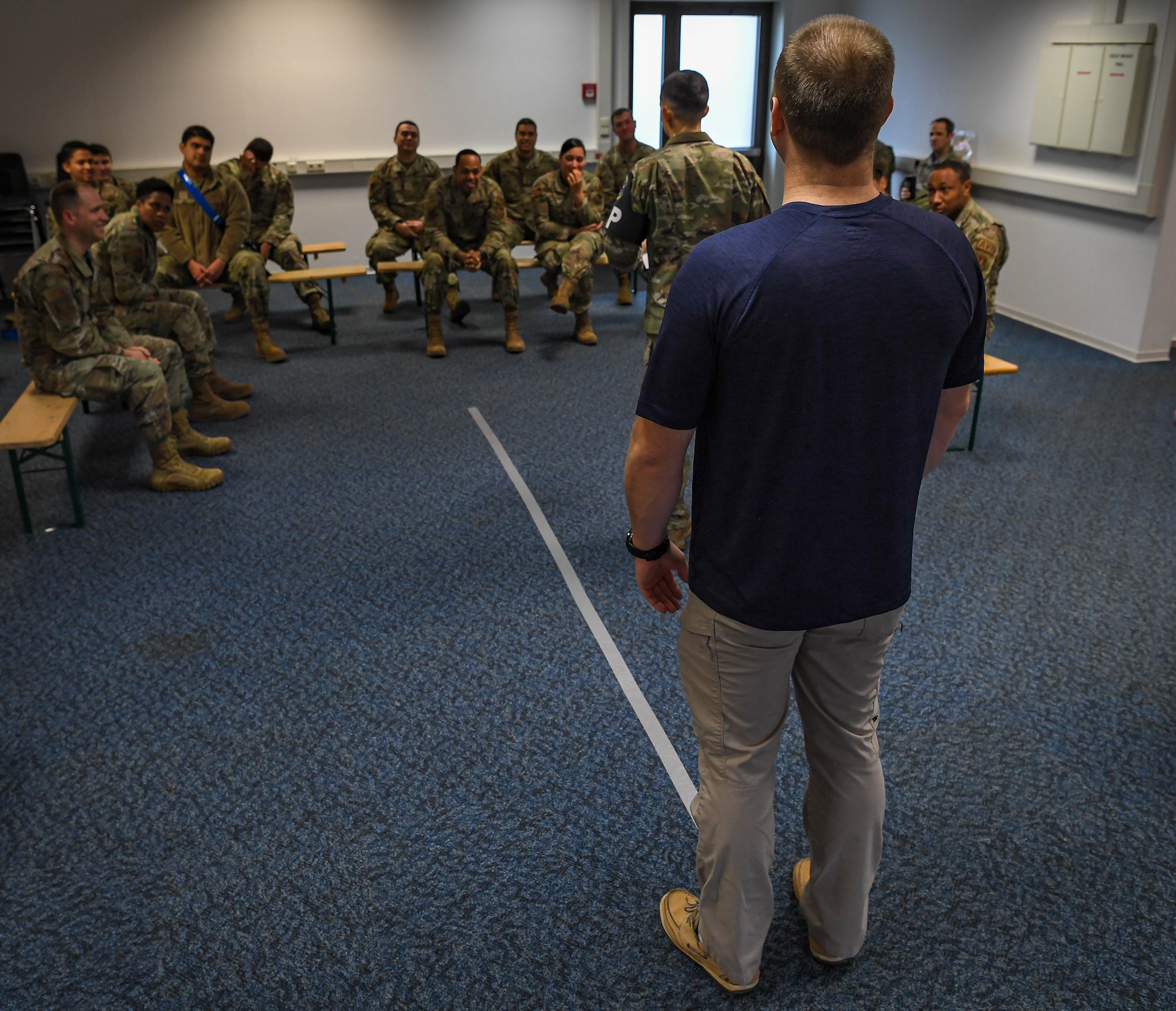 U.S. Air Force Staff Sgt. Madison Alicea, 569th United States Forces Police Squadron unit training instructor, performs standard field sobriety tests on 86th Maintenance Group Airmen at Ramstein Air Base, Germany, Dec. 16, 2021. The purpose of the Wet Lab event is to show the direct impact of alcohol consumption on various body compositions in order to deter people from drinking and driving. (U.S. Air Force photo by Airman Jared Lovett)
