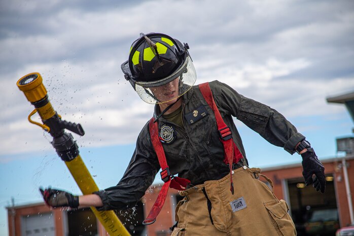 U.S. Marine Corps Cpl. Andrew House, a firefighter with Aircraft Rescue and Firefighting, drops a charged hose during an initial Firefighter Assessment conducted at Marine Corps Air Station Cherry Point, North Carolina, Jan 6, 2022. The Firefighter Assessment is an annual requirement to ensure all firefighters are able to perform their duties safely and properly. Firefighters were given the opportunity to run an intial assessment in order to ensure success when they conduct the real thing during their birth month.