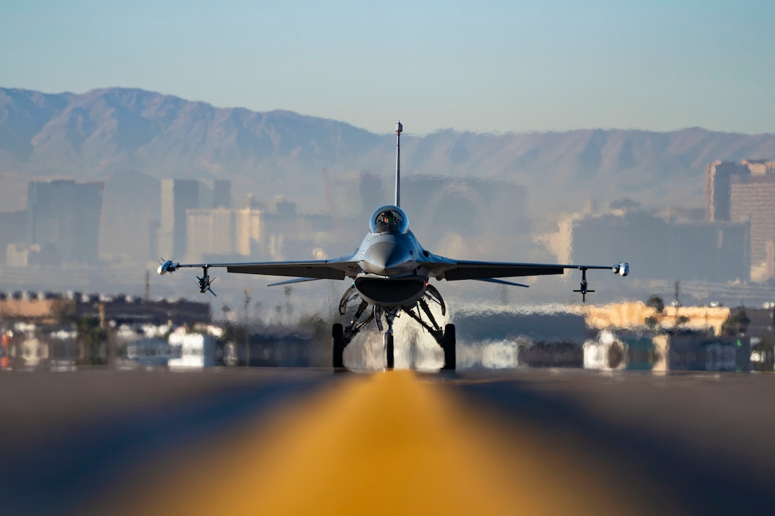 An aircraft travels along the yellow line of a runway.