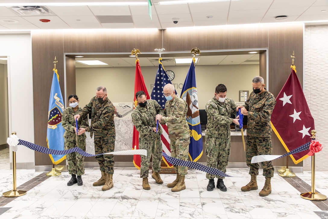 U.S. Marine Corps Lt. Gen. William Jurney, second from left, commanding general II Marine Expeditionary Force, Lt. Gen. Ronald Place, third from right, director of Defense Health Agency and Brig. Gen. Andrew Niebel, right, commanding general of Marine Corps Installations East, cut a ribbon on Camp Lejeune, North Carolina, Jan. 10, 2022. During the ceremony service members cut a ribbon to the 2d Dental Battalion Naval Dental Center marking the end of construction for the new facility. (U.S. Marine Corps photo by Cpl. Scott Jenkins)