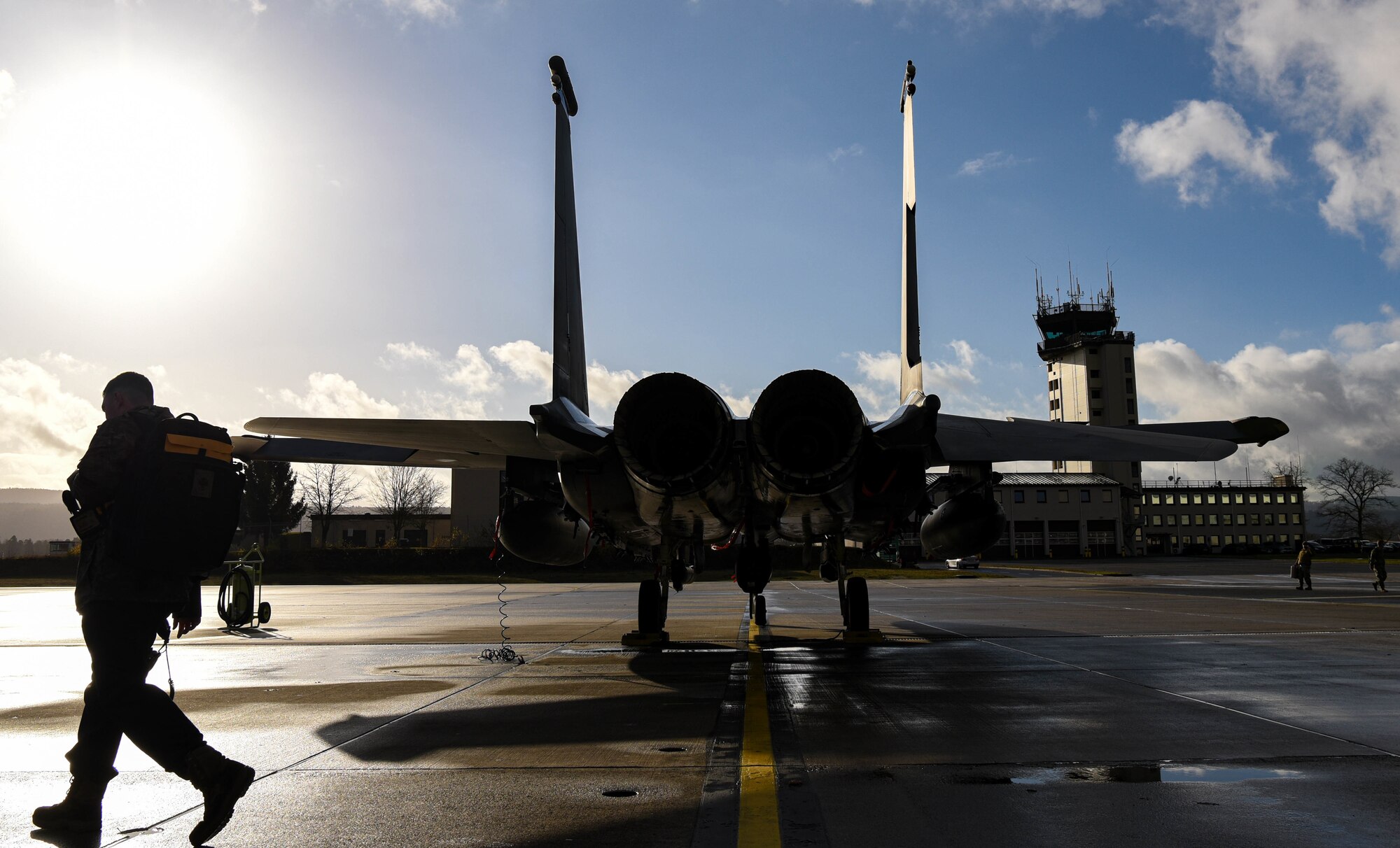 Airman carries maintenance gear around aircraft.