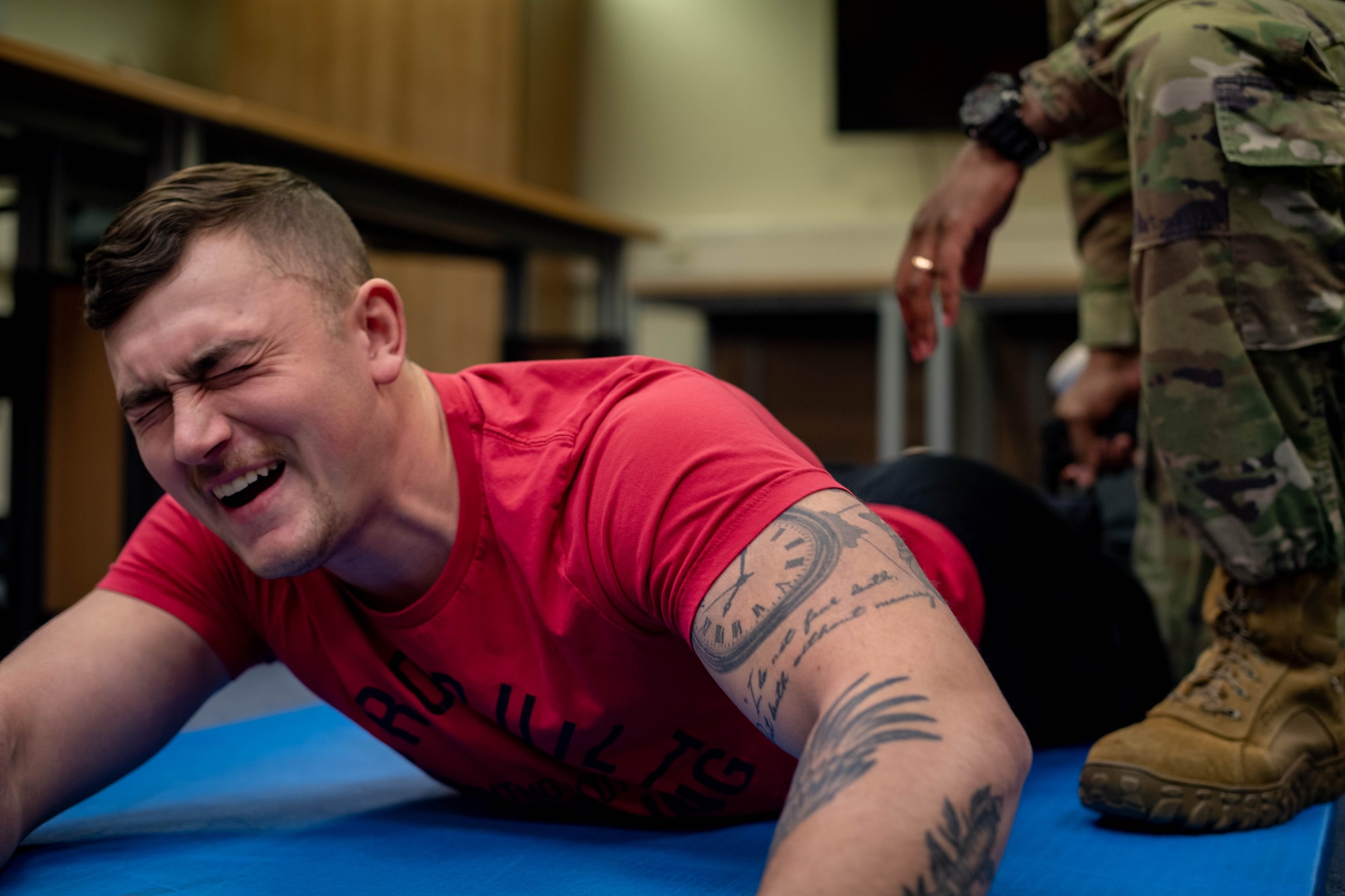 U.S. Air Force Airman Tyler Benner, 86th Vehicle Readiness Squadron ground transporter, experiences the pain response from a drive-stun on a Taser X26P at Vogelweh Air Station, Germany, Nov. 29, 2021. In the event that an officer misses when firing the weapon, they are able to use the weapon as a direct-contact stun, called the drive-stun, which is designed for pain compliance. (U.S. Air Force photo by Airman Jared Lovett)