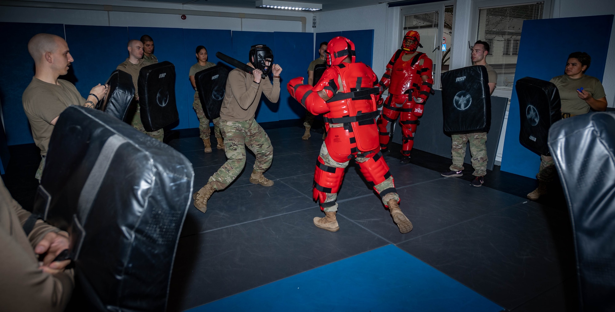Airmen assigned to the 569th United States Forces Police Squadron, undergo Red Man training at Vogelweh Air Station, Germany, Dec. 6, 2021. During Red Man training, Airmen are provided with safety gear and a baton-like weapon and must defend themself from the instructor who’s wearing Red Man training gear. (U.S. Air Force photo by Airman Jared Lovett)