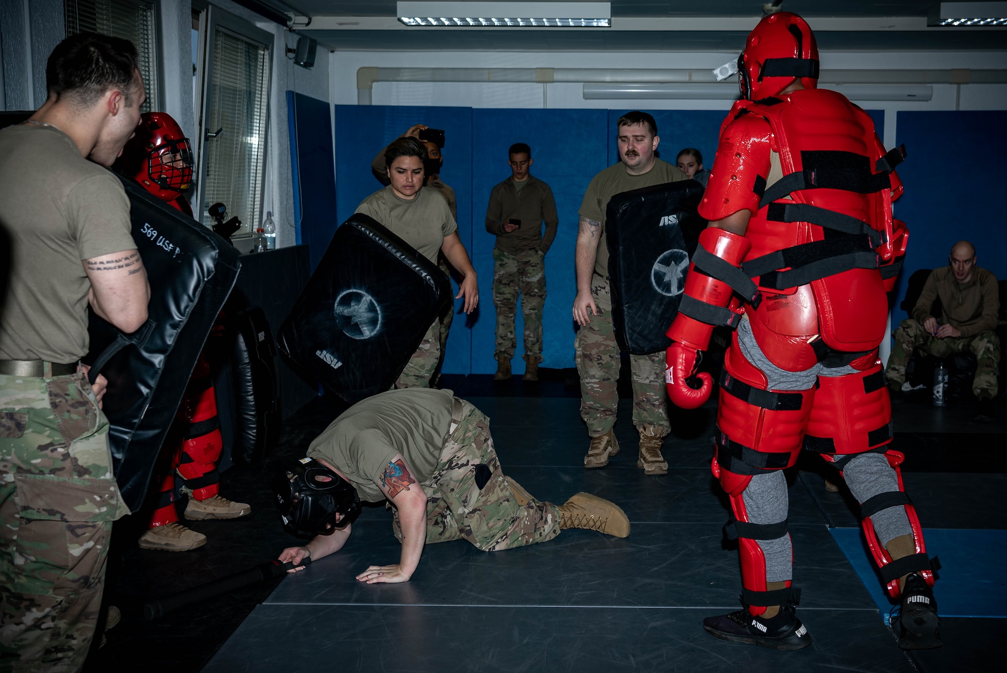 Airmen assigned to the 569th United States Forces Police Squadron, undergo Red Man training at Vogelweh Air Station, Germany, Dec. 6, 2021. Red Man training serves to prepare Airmen for a real-life physical altercation with a violent individual and build their confidence so that they respond to such a situation appropriately. Red Man training provides 569th USFPS Airmen with a controlled environment to train on how to react to a physical altercation with a violent individual. (U.S. Air Force photo by Airman Jared Lovett)